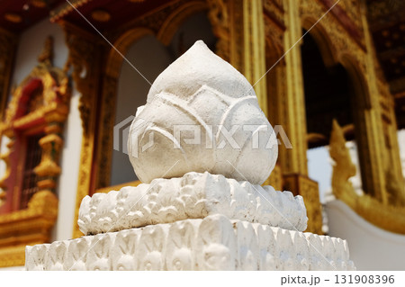Floral statue and lotus stucco carvings decorated on pole head in the ancient golden temple Floral statue and lotus stucco carvings decorated on pole head in the ancient golden temple 131908396
