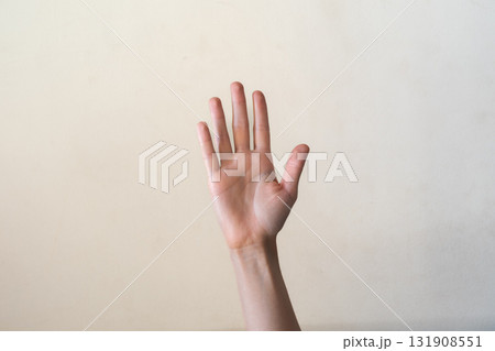A close-up of a human hand with fingers extended, palm facing forward. The hand is light-skinned with visible details of the fingers and palm. 131908551