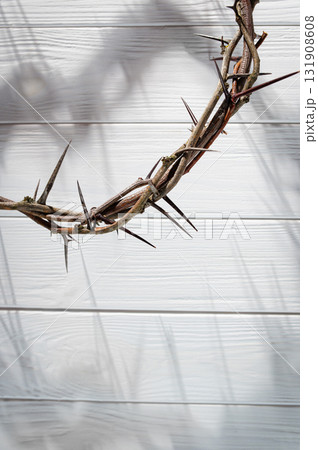 Jesus Christ Crown of thorns shadow against wooden textured gray surface, symbol spiritual pain and redemptive struggle Banner good Easter concept Christian friday background, 131908608