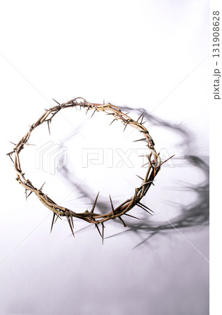 Jesus Crown of thorns casting a distinct shadow for Christian background, Easter concept creating a symbolic image of suffering, sacrifice, for space remembrance Copy text 131908628