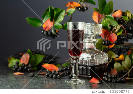 Black chokeberry liqueur and fresh berries. Black chokeberry liqueur and fresh berries. 131908775