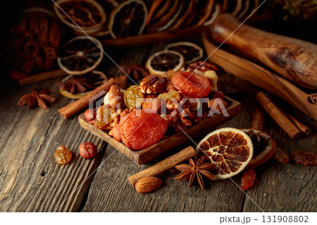 Dried fruits and nuts on an old wooden table. 131908802