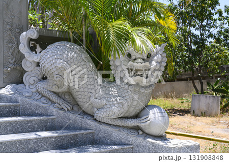 Sculpture of buddhist dragon and tropical trees near the Chua Tu Van Pagoda 131908848