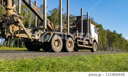 Timber truck with empty trailers on the highway. Timber export and shipping concept Timber truck with empty trailers on the highway. Timber export and shipping concept 131909449