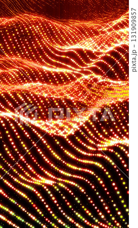 Glowing wave pattern of orange and yellow particles forming abstract digital energy background 131909857