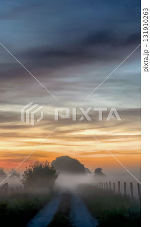 A Serene Sunrise Over a Misty Road Landscape That Inspires Tranquility and Exploration 131910263
