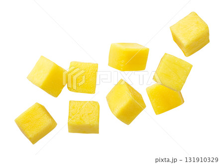 Mango cubes flying close-up on a white. Isolated 131910329