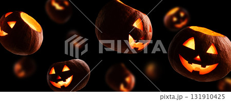 The image features floating Halloween JackoLanterns set against a dark and eerie background The image features floating Halloween JackoLanterns set against a dark and eerie background 131910425