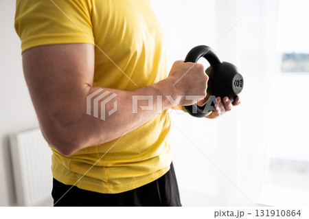 Sporty Man Doing Arm And Shoulder Home Workout With Dumbbells 131910864