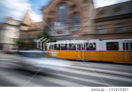 Yellow City Tram Rushes In Motion On A Blurred Budapest Street 131910867