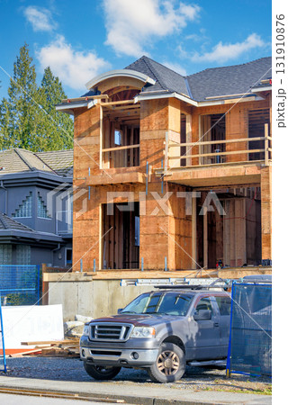 Brand new house with big compactor's truck parked in front 131910876