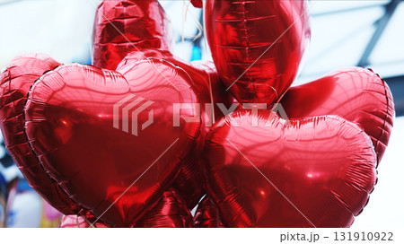 Red Heart-Shaped Balloons Tied Together On Strings 131910922