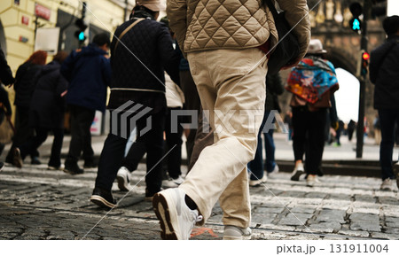 Pedestrians Crossing Road On Stone Road Made Of Rubble In Historical Center Of European City Pedestrians Crossing Road On Stone Road Made Of Rubble In Historical Center Of European City 131911004