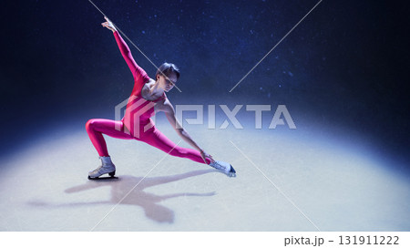 Female figure skater in pink bodysuit stretching arm and leg in dynamic emotional pose on ice Female figure skater in pink bodysuit stretching arm and leg in dynamic emotional pose on ice 131911222