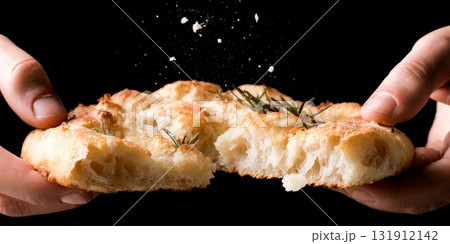 Homemade sweet focaccia is being torn apart, revealing its soft texture, ideal for autumn gatherings and family meals Homemade sweet focaccia is being torn apart, revealing its soft texture, ideal for autumn gatherings and family meals 131912142