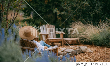 Person enjoys a peaceful moment in a sustainable yard filled with ornamental grasses and water-wise gardening features 131912184