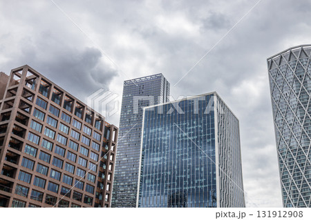 Modern glass skyscrapers and corporate towers under dramatic overcast sky 131912908