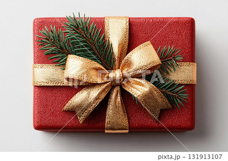 Holiday-themed present wrapped with a festive bow. Christmas Gift Box with a sprig of pine on white background. Christmas traditions and seasonal joy. Holiday-themed present wrapped with a festive bow. Christmas Gift Box with a sprig of pine on white background. Christmas traditions and seasonal joy. 131913107