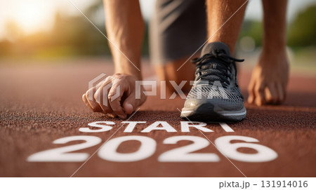 Runner prepares at starting line marked with 2026, symbolizing fresh start and determination for new year Runner prepares at starting line marked with 2026, symbolizing fresh start and determination for new year 131914016