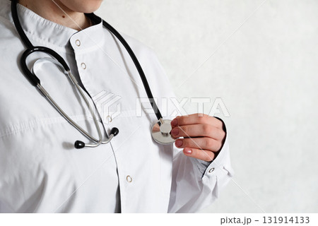 Healthcare professional taking notes in a clinical setting during a routine check-up Healthcare professional taking notes in a clinical setting during a routine check-up 131914133