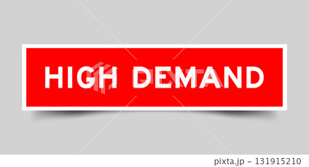Red color square shape sticker label with word high demand on gray background 131915210