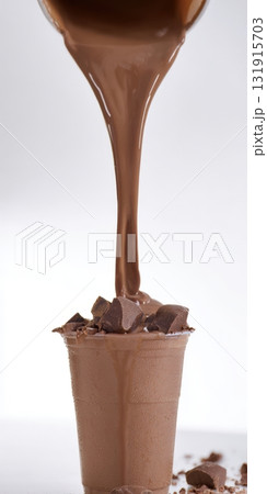 Chocolate milkshake pouring into a cup with chunks 131915703