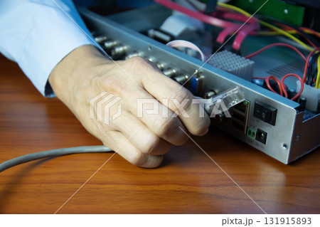 Technicians installing LAN cables at CCTV camera recorders 131915893