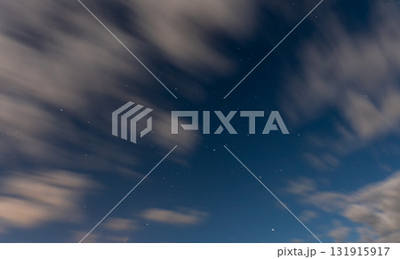 Starry night sky with moving soft clouds 131915917