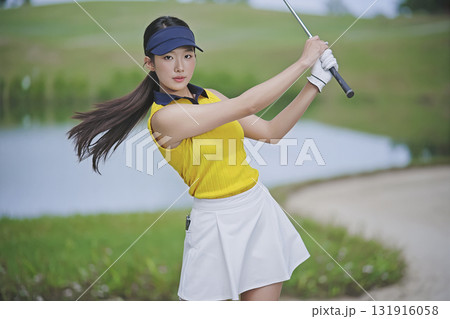 portrait of a young woman hold a basket in the garden 131916058