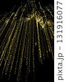 Golden lights cascading strings sparkle bokeh glowing night black background festive abstract 131916077