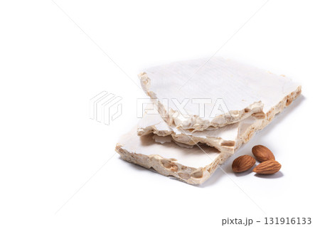 Delicious almond nougat on wooden table. Traditional Christmas sweet Delicious almond nougat on wooden table. Traditional Christmas sweet 131916133