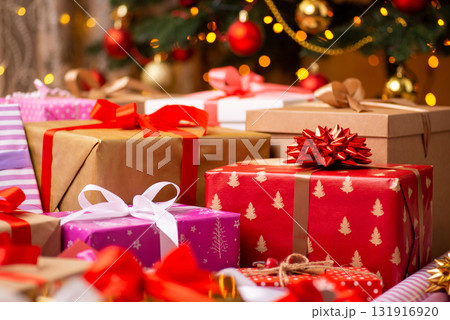 Christmas presents in colorful wrapping paper on the floor under Christmas tree. Surprises, memories, happy winter time concept Christmas presents in colorful wrapping paper on the floor under Christmas tree. Surprises, memories, happy winter time concept 131916920