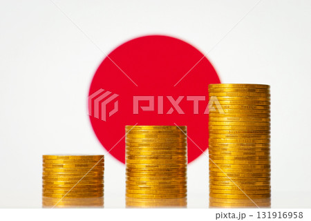 Three stacks of golden coins on the background of flag of Japan. Rise of economy of the country 131916958