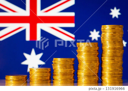 Upcoming graph made of golden coins on the background of flag of Australia. Concept of development, growth, economic progress of Australia Upcoming graph made of golden coins on the background of flag of Australia. Concept of development, growth, economic progress of Australia 131916966