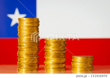 Financial crisis in Chile concept. Descending chart of coins in front of Chile flag Financial crisis in Chile concept. Descending chart of coins in front of Chile flag 131916970