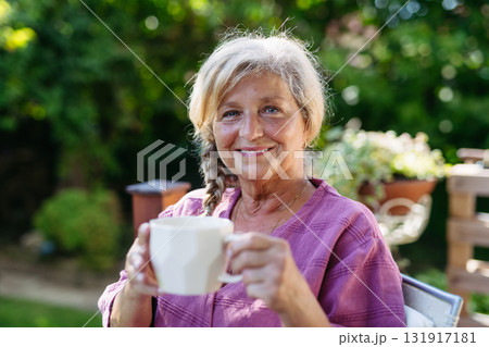 Quiet morning in garden for older woman. Self ritual with coffee. Quiet morning in garden for older woman. Self ritual with coffee. 131917181