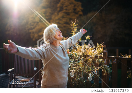 Senior woman enjoying warm autumn sun. Senior woman enjoying warm autumn sun. 131917379