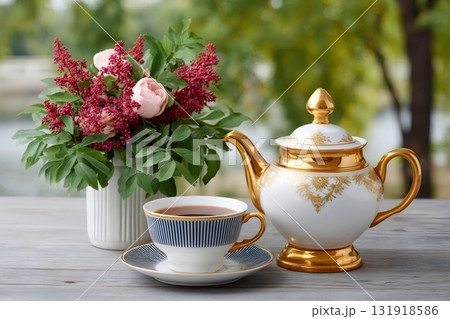 Teacup with hot tea on table with flowers 131918586