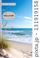Beautiful sea, sky and sandy beach with Welcome sign, vertical image. 131919158