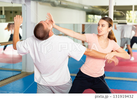 Woman and man practicing self defense techniques 131919432