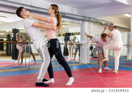 Self-defense course - woman strikes painful blow in the eyes of man 131919453