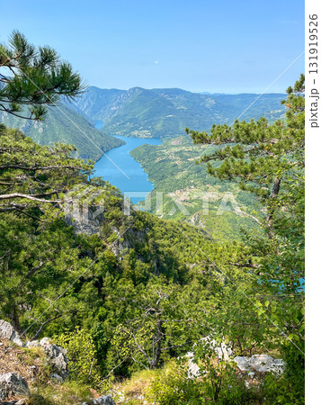 Canyon river meandering among green forested mountains; nature landscape photography under  blue sky 131919526