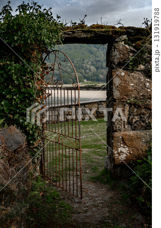Stone Wall With Open Door At Old Cottage In Snowdonia Nationalpark In Wales, United Kingdom Stone Wall With Open Door At Old Cottage In Snowdonia Nationalpark In Wales, United Kingdom 131919788
