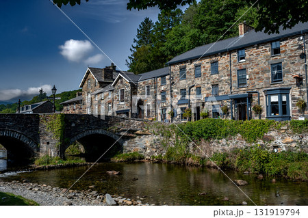 Stone Bridge And River In The City Of Beddgelert In Snowdonia National Park In Gwynedd, Wales, United Kingdom Stone Bridge And River In The City Of Beddgelert In Snowdonia National Park In Gwynedd, Wales, United Kingdom 131919794