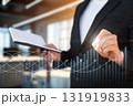 Business professional analyzing growth trends in modern office. 131919833
