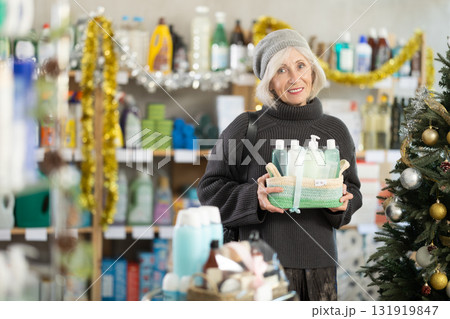 Mature woman shopping for Christmas presents at home goods store Mature woman shopping for Christmas presents at home goods store 131919847
