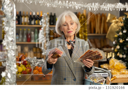 Elderly woman is looking and choose hamon in store. Elderly woman is looking and choose hamon in store. 131920166
