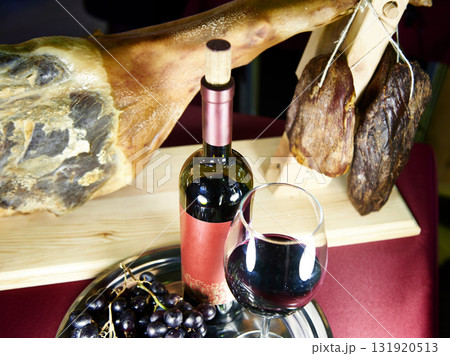Bottle of wine with glass and ham 131920513