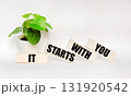 IT STARTS WITH YOU written on wooden blocks on a white background. A place to copy. 131920542