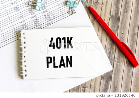 The notebook that says "Planning 401k". Next to the pen and financial statements 131920546
